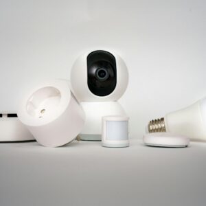 A range of smart home devices including camera and lightbulb in a minimalist setup.